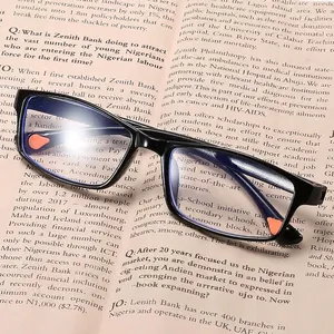 Ultralight black full-rim reading glasses with anti-blue light lenses on a book