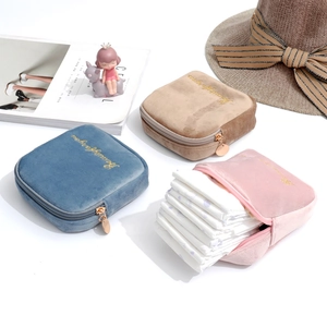 Detailed view of plush velvet makeup bags with gold embroidery and multi-compartment storage