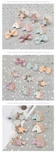 Close-up of glittery unicorn hair clips and bow pins featuring sequins and soft tulle