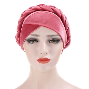 Detail of pink velvet turban cap featuring a stylish braided knot and soft texture