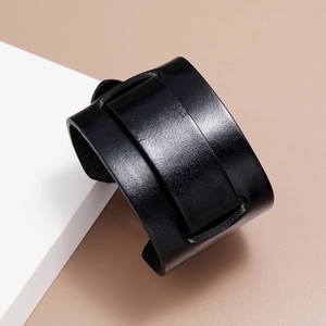 Detailed view of wide black leather cuff bracelet with high-quality grain texture and finish