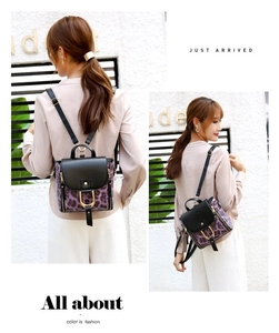 Lifestyle view of purple leopard print backpack with gold zippers shown on model