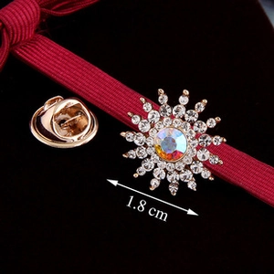 Detailed macro view of 1.8 cm sunburst brooch featuring iridescent crystals and gold plating