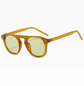 Detail view of amber frame pilot sunglasses with light lenses and durable metal hinges