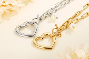 Détail de bracelets breloques cœur avec perles et fermoir à bascule en or et argent