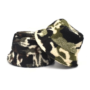 Close-up of thick camouflage sherpa fleece bucket hats showing soft warm texture