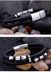 Detailed view of men's double-layer braided leather bracelet with magnetic metal clasp