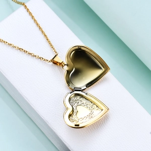 Golden heart locket necklace with floral engraving and inner photo frame window