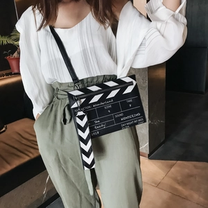 Fashionable black movie clapperboard crossbody bag with printed text and wrist strap