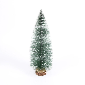 Mini green Christmas tree with white snow flocking and a round wooden base tabletop decor