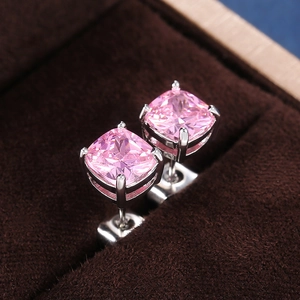 Macro shot of pink square-cut zircon earrings with silver-tone four-prong setting