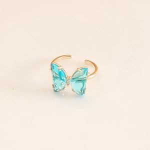 Detail of blue butterfly ring with gold adjustable band and transparent crystal wings