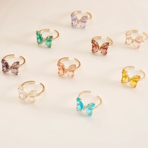 Adjustable gold-plated butterfly rings featuring vibrant colorful glass crystals in various shades