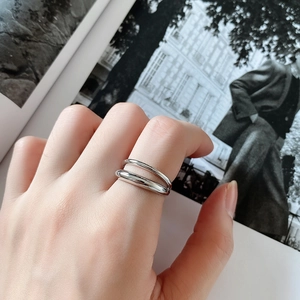 Close-up of double-layer 925 silver ring on hand with elegant fashion magazine background