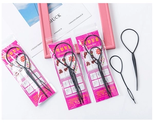 Close-up of black plastic hair styling tool set with two sizes for braid styling