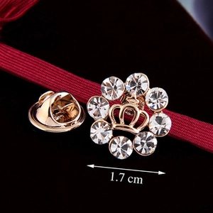 Macro view showing crown brooch details with crystals and size marking of 1.7 cm