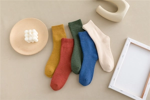 Five pairs of thick cotton crew socks in warm autumn colors with ribbed cuffs for winter