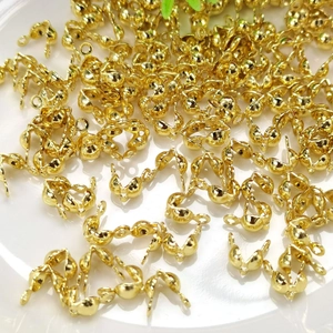 14k gold filled jewelry fold-over crimp ends for DIY bracelet making on white plate
