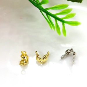 Macro view of gold and silver plated jewelry crimp bead connectors for DIY bracelet making