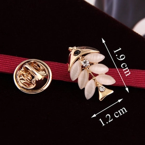 Macro view of fishbone brooch with opal stones and size dimensions 1.9 x 1.2 cm