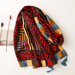 Artistic geometric print scarf with colorful tassels and silk-like fabric texture