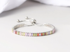 Detailed close-up of adjustable tennis bracelet with colorful rectangular cubic zirconia