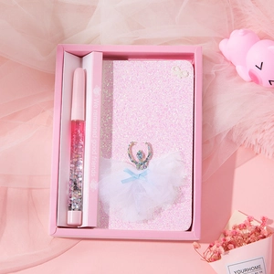 Close-up of pink stationery gift set featuring a sequin notebook and ballerina detail