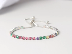 Detailed macro view of a colorful zircon tennis bracelet with adjustable bolo sliding closure