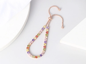 Detail of rose gold tennis bracelet with colorful crystals and adjustable slider closure
