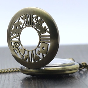 Macro detail of bronze Alice in Wonderland pocket watch with intricate hollow engraving