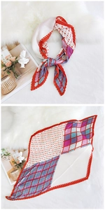 Detail of pleated silk scarf featuring colorful geometric patterns and red crimped edges
