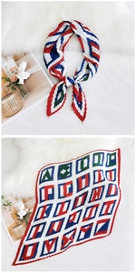 Detailed view of pleated silk scarf with colorful geometric patterns on white fur