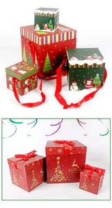 Detail of festive Christmas gift boxes with red and green patterns and silk ribbons