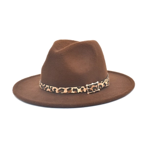 Detail of wool fedora hat with leopard print band and decorative gold buckle