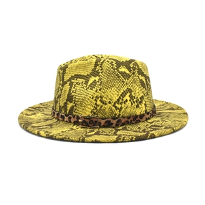 Yellow snakeskin fedora hat with leopard print band and golden buckle on white background