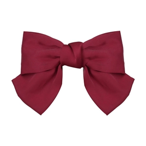 Elegant red satin oversized bow hair clip with vintage long ribbon on white background