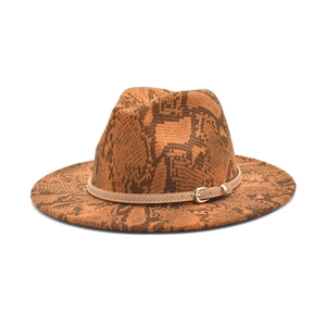 Detail of orange-brown snakeskin pattern on a wide-brim wool fedora with gold buckle