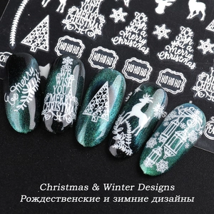 Luminous Christmas nail stickers with white elk and snowflake patterns on green cat eye nails
