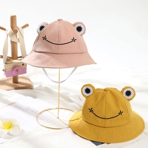 Detail of pink and yellow cotton frog bucket hats with windproof drawstring and embroidery