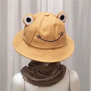 Bright yellow frog bucket hat for kids with cute 3D eyes and embroidered smile detail