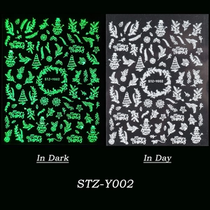 Glow in the dark Christmas nail art stickers showing snowman and snowflake patterns