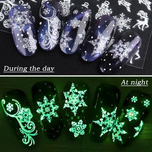 Luminous Christmas snowflake nail decals showing day and night glowing green effect