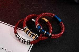 Macro detail of red woven leather cords with gold, silver and blue steel accents