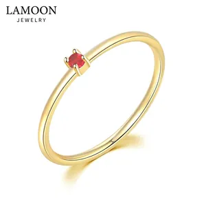Minimalist gold ring featuring a round cut red zircon in a four-prong setting