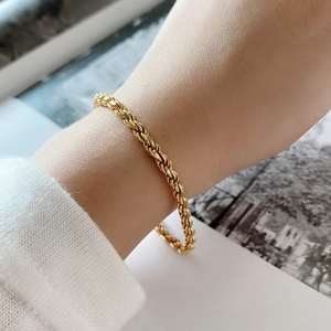 Minimalist 925 sterling silver rope chain bracelet in gold finish worn on wrist
