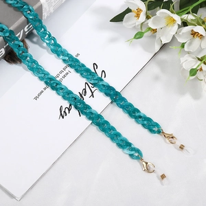 Detail of turquoise acrylic chunky chain with gold lobster clasp and rubber loop