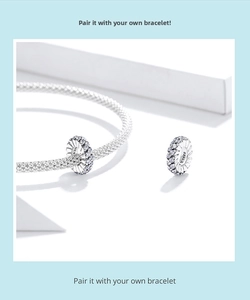 Detail of S925 sterling silver charm bead with white zircons on mesh bracelet