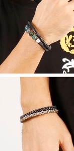 Detail of men's double-layer leather chain bracelet with titanium steel lion head bead