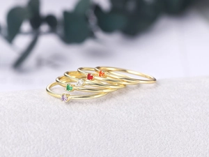 Set of five slender gold plated rings featuring colorful zirconia stones for stacking