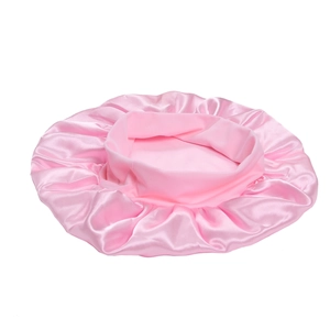 Detailed view of pink silk satin bonnet featuring a wide elastic band and ruffle edge